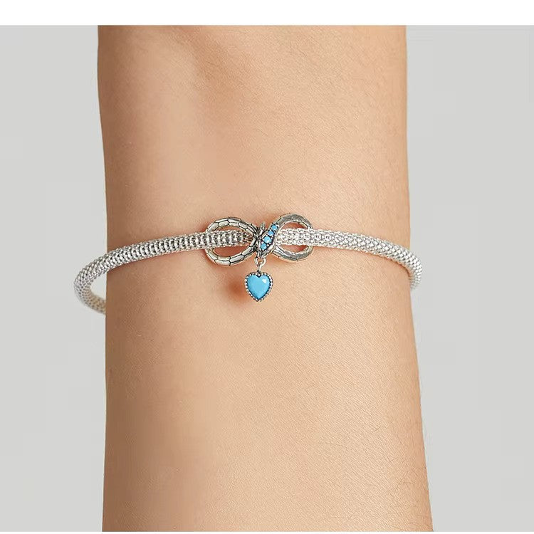 Elegant charm in 925 Sterling Silver: infinity snake design with blue heart. Pandora compatible – meaningful gift for love & eternity.