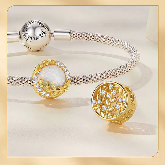 A Sterling 925 silver charm with a gold color finish, featuring an opal wheat leaf design, surrounded by clear zirconia stones. back side is studded leaves