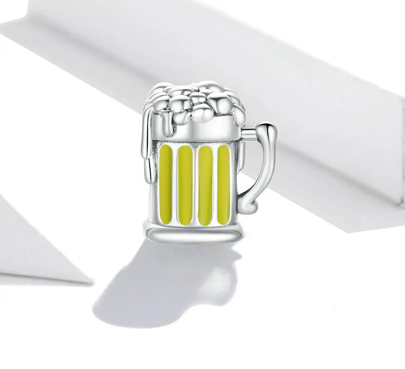 Silver charm shaped like a beer mug with yellow stripes on a white background