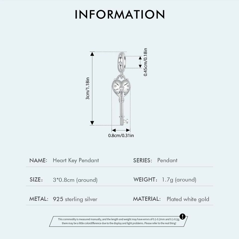 sterling 925 sterling silver Key charm, its in the shape of a heart with small zircon stones.