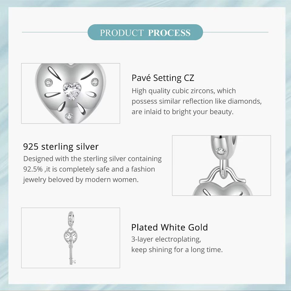 sterling 925 sterling silver Key charm, its in the shape of a heart with small zircon stones.