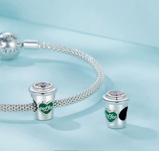 A Sterling 925 silver coffee cup charm with a heart-shaped 'COFFEE' logo on the side and a clear crystal on top. fit pandora bracelet