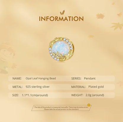 A Sterling 925 silver charm with a gold color finish, featuring an opal wheat leaf design, surrounded by clear zirconia stones. back side is studded leaves. product measurements