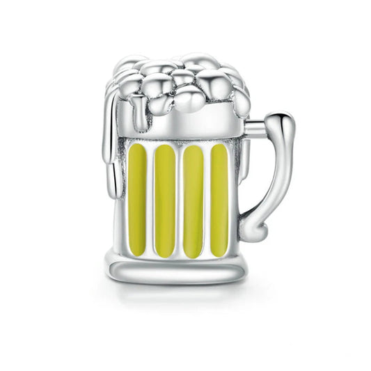 Silver mug charm with yellow liquid on a white background