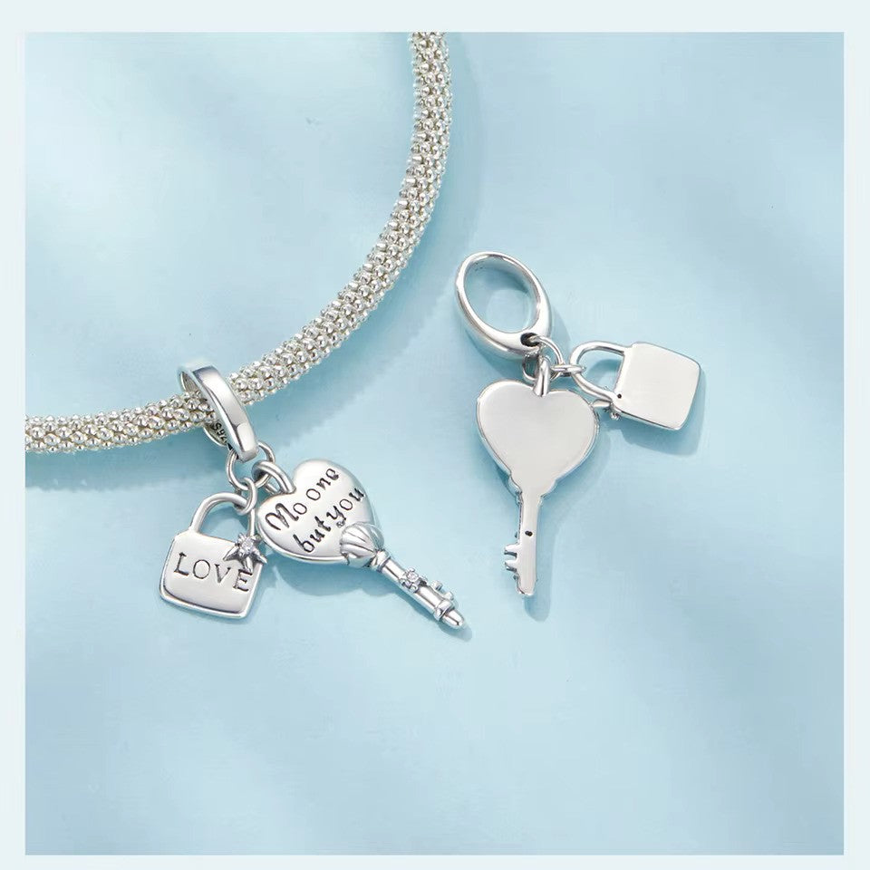 sterling 925 silver charm with a lock engraved with ( love ) and a star with a small zircon stone and a key with heart engraved with ( no one but you ) and the body of the key is shell with a small zircon stone.