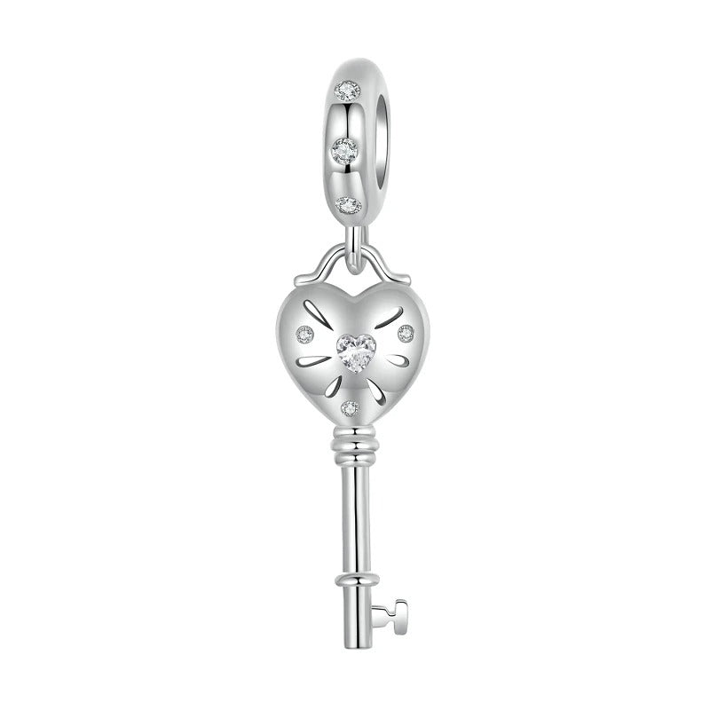 sterling 925 sterling silver Key charm, its in the shape of a heart with small zircon stones.
