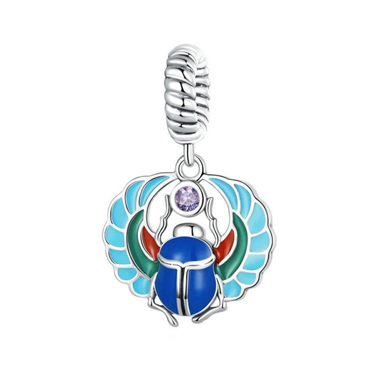 Egyptian scarab charm with wings in blue, turquoise red and green colors along with a light purple zircon stone in the middle